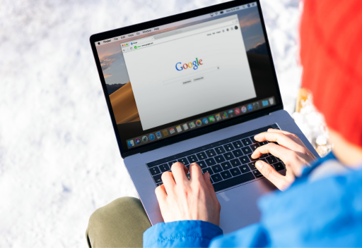 Woman uses laptop open to the Google home page